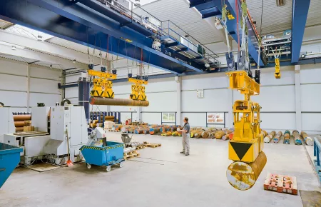 Process cranes with two 8-tonne hoist units and magnet systems in a steel service centre for pre-processing solid steel bar stock