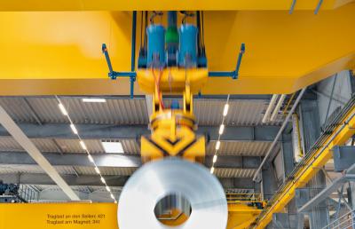 Safe and gentle handling of steel coils with magnet lifting equipment.