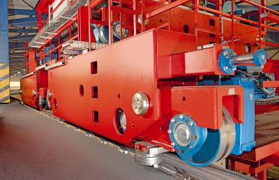 Wheel sets with lateral guide rollers, driven by Demag offset geared motors on a double-girder overhead travelling crane