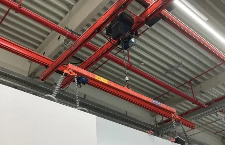 Demag DC-Com chain hoists lift and lower the components, in this case on a load bar.